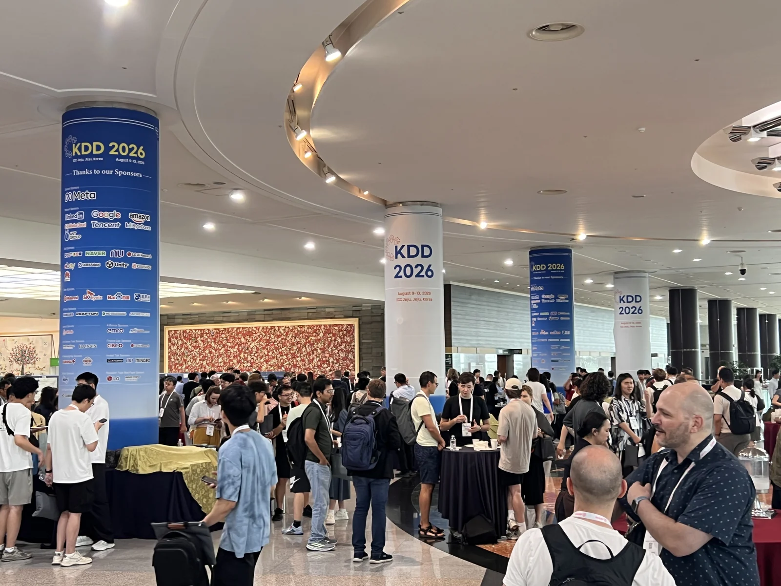 Researchers and attendees gathering in the ICC Jeju lobby during KDD 2026.